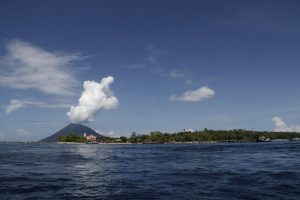 Stunning view of Manado Tua volcano and coast under a clear blue sky, perfect for travel enthusiasts.